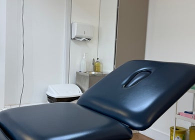 Comfortable treatment room at Aesthetic in Manchester, England, GB featuring a sleek therapy bed.