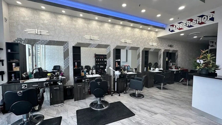 Modern barber area at EKI ROYAL BEAUTY LOUNGE, Edmonton, Alberta, CA with stylish chairs and mirrors.