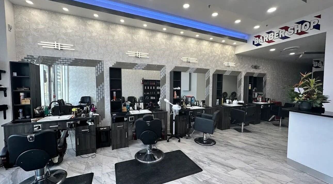 Modern barber area at EKI ROYAL BEAUTY LOUNGE, Edmonton, Alberta, CA with stylish chairs and mirrors.