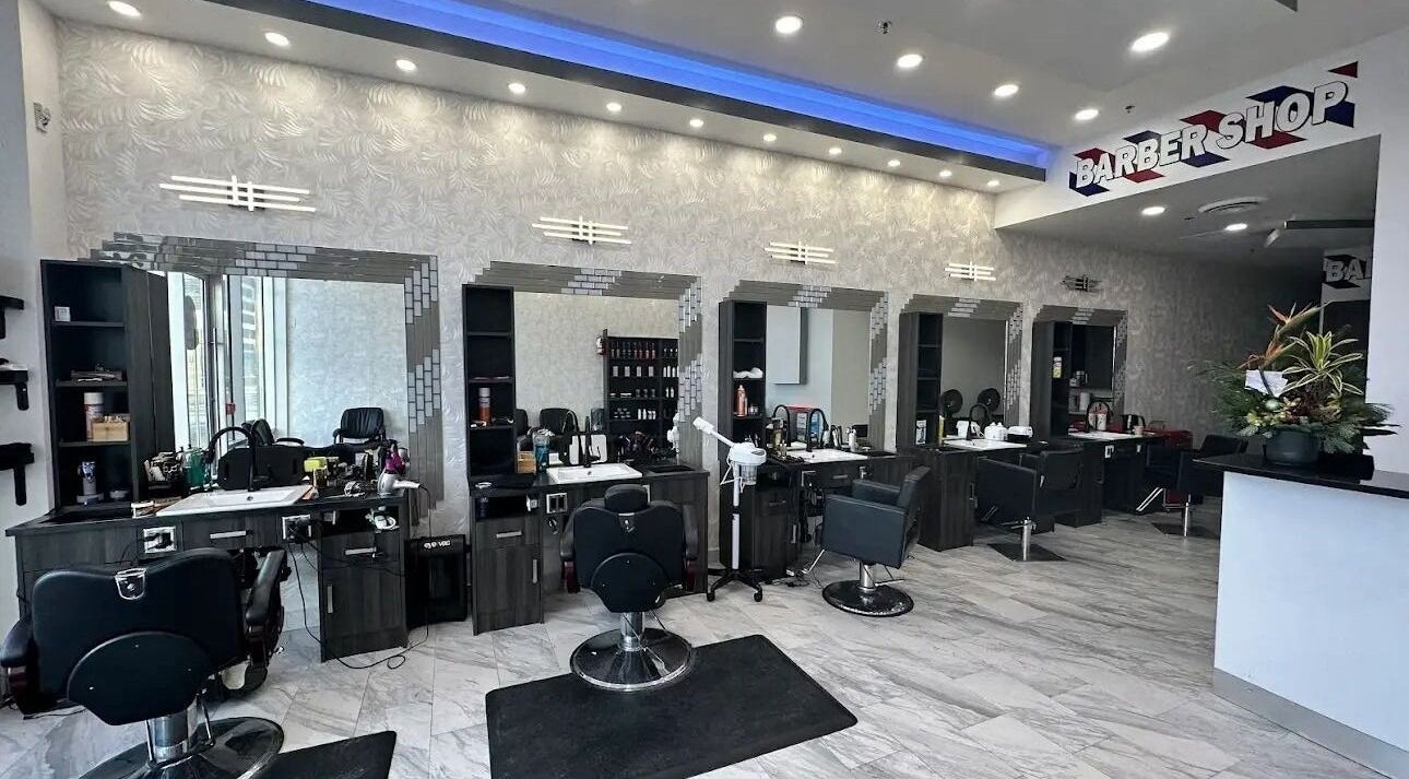 Modern barber area at EKI ROYAL BEAUTY LOUNGE, Edmonton, Alberta, CA with stylish chairs and mirrors.