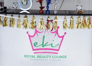 Entrance of EKI ROYAL BEAUTY LOUNGE in Edmonton, Alberta, CA decorated with colorful balloons and gold tassels.