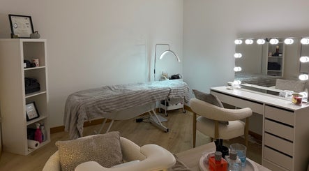 Therapy room at Belle Beauty, Maud, Scotland, GB, featuring a treatment bed and illuminated vanity mirror.