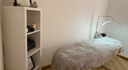 Cosy treatment room at Belle Beauty, Maud, Scotland, GB with a plush treatment bed and soft lighting.