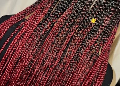 Red and black box braids at Ataahua Braids in Whanganui, NZ showcase intricate hair artistry.