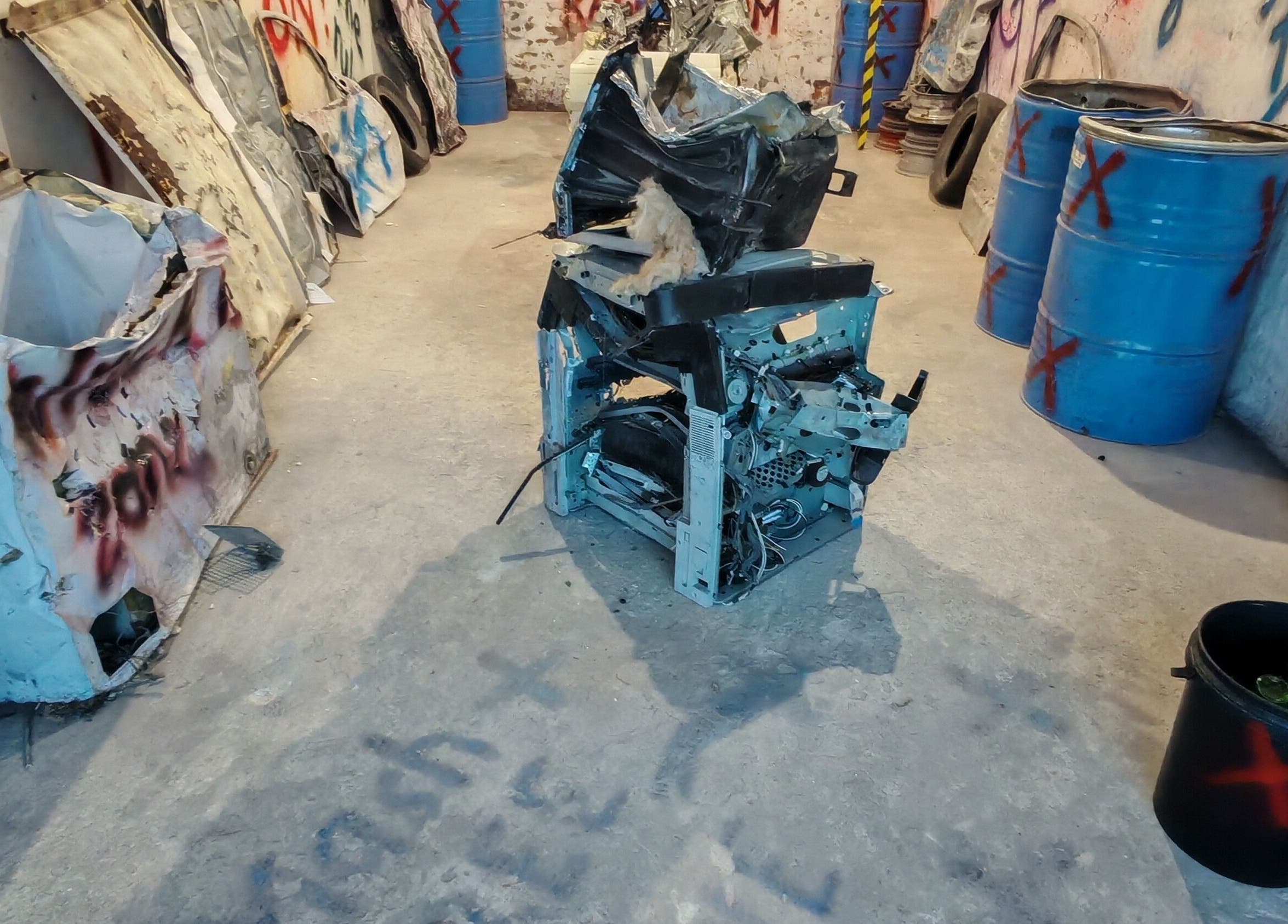 Bliksem Rage Room venue in Gqeberha, Eastern Cape, ZA featuring scattered debris and painted barrels.