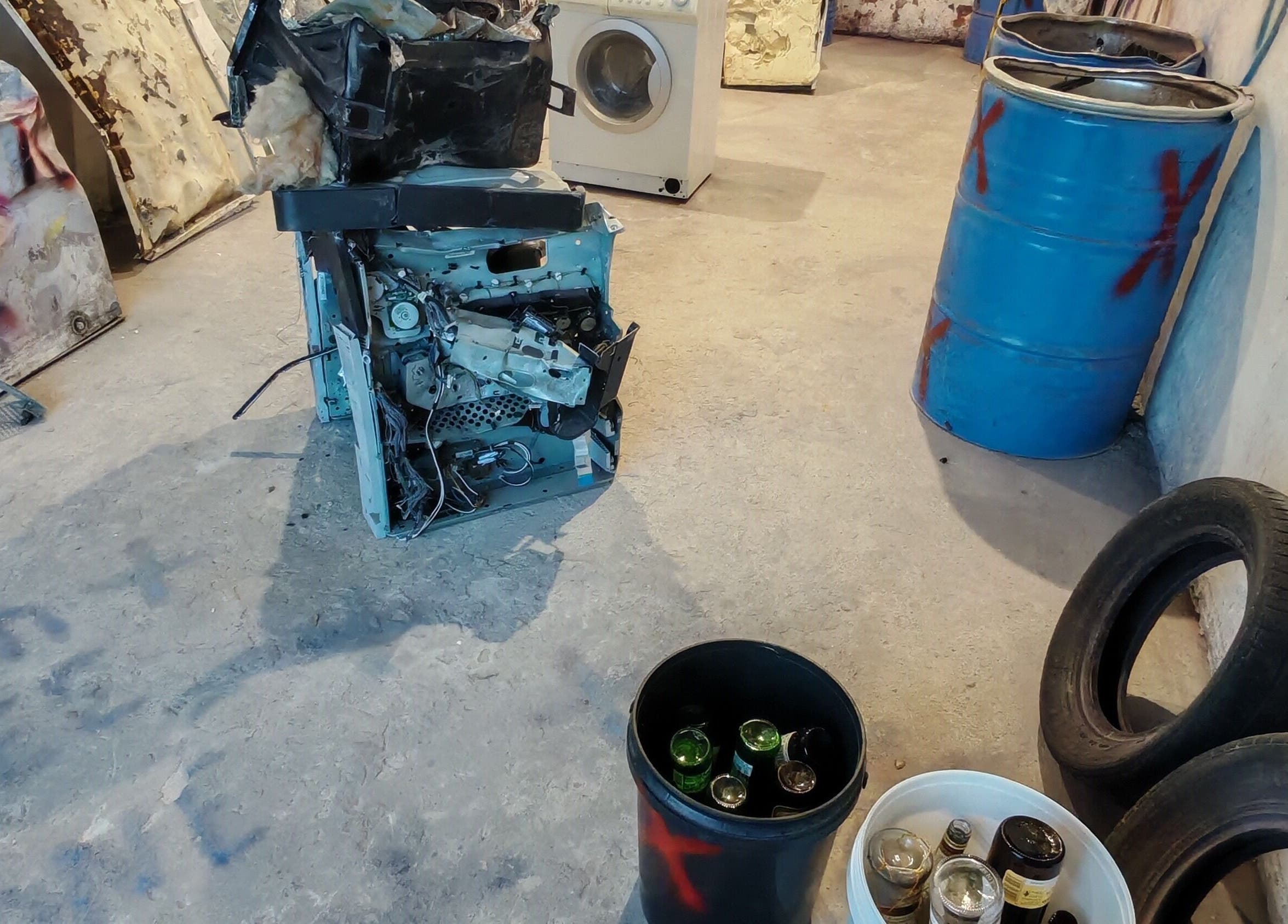 Bliksem Rage Room in Gqeberha, Eastern Cape, ZA. Shattered appliances and barrels for stress-relief smashing.