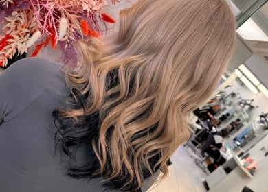 Stylish blonde and black wavy hairstyle at Dynamix Hair Salon, Carluke, Scotland, GB.