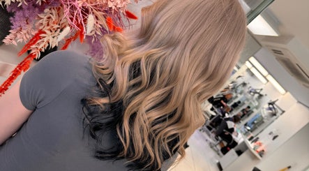 Stylish blonde and black wavy hairstyle at Dynamix Hair Salon, Carluke, Scotland, GB.