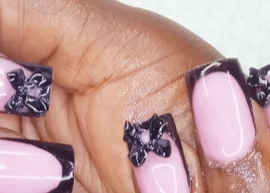 Stylish pink nails with black bows at GrapUglow Beauty Academy, Benoni, Gauteng, ZA.