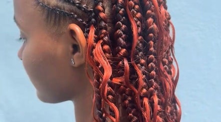 Intricate red braids styled at Cr_.hairstyles, Willemstad, Curaçao, CW for a stylish look.