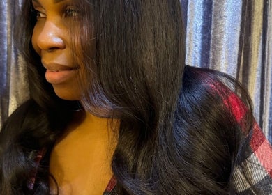 Close-up of a woman with sleek, shiny hair at TAMhair in Milton Keynes, England, GB.