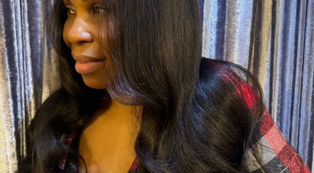 Close-up of a woman with sleek, shiny hair at TAMhair in Milton Keynes, England, GB.