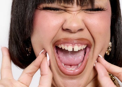 Smiling person with vibrant expression, styled at TAMhair in Milton Keynes, England, GB.