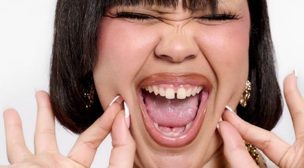 Smiling person with vibrant expression, styled at TAMhair in Milton Keynes, England, GB.