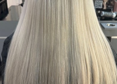 Elegant blonde hair styled smoothly at TAMhair in Milton Keynes, England, GB.