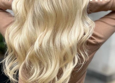 Blonde wavy hair styled at TAMhair in Milton Keynes, England, GB showcasing vibrant beauty.