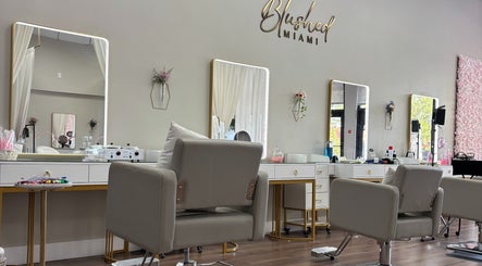 Modern beauty studio at Blushed Miami, Palmetto Bay, FL, US with stylish chairs and mirrors.