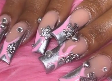 Elegant nail art with silver and pink designs at Nailsbydarri, Shaker Heights, Ohio, US.
