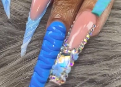 Elegant blue acrylic nails with rhinestones at Nailsbydarri, Shaker Heights, Ohio, US.