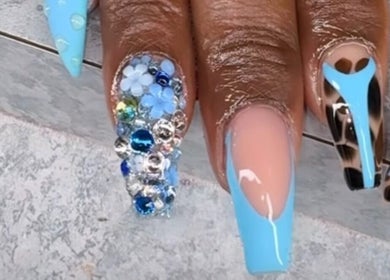 Stunning nail art with crystals and blue tones at Nailsbydarri, Shaker Heights, Ohio, US.