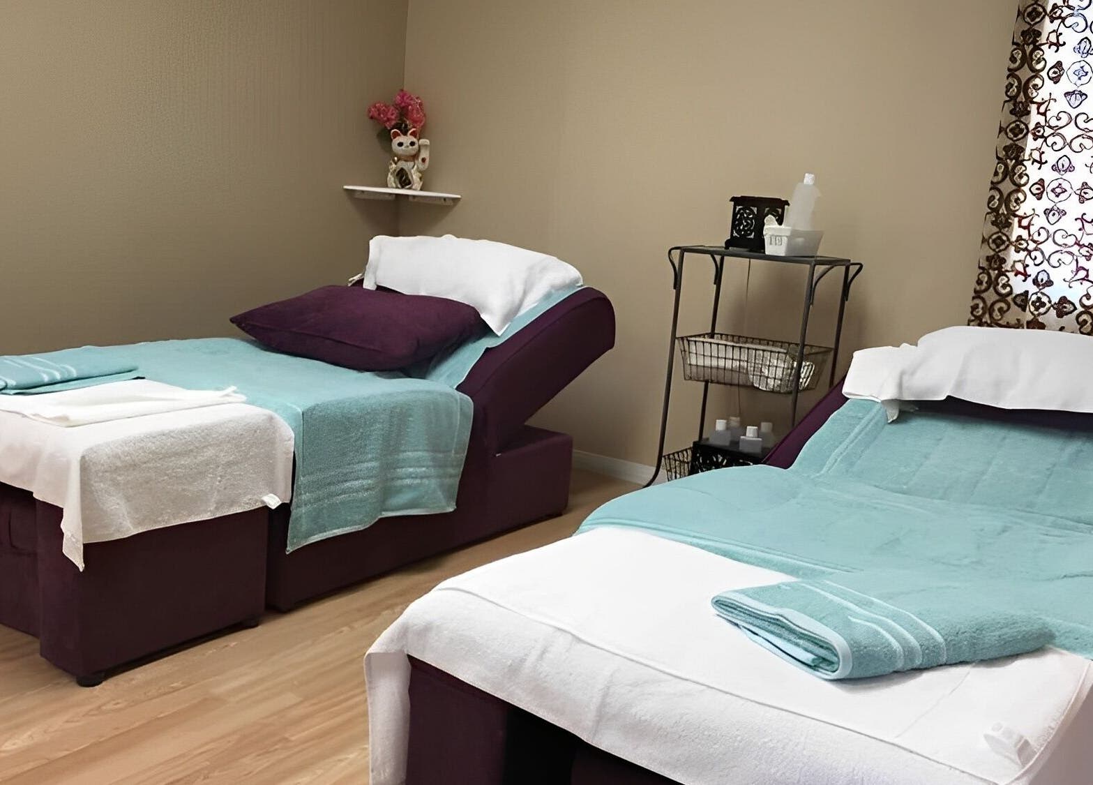 Cozy treatment beds at Rainbow Spa in Riverside, California, US, inviting relaxation and wellness.