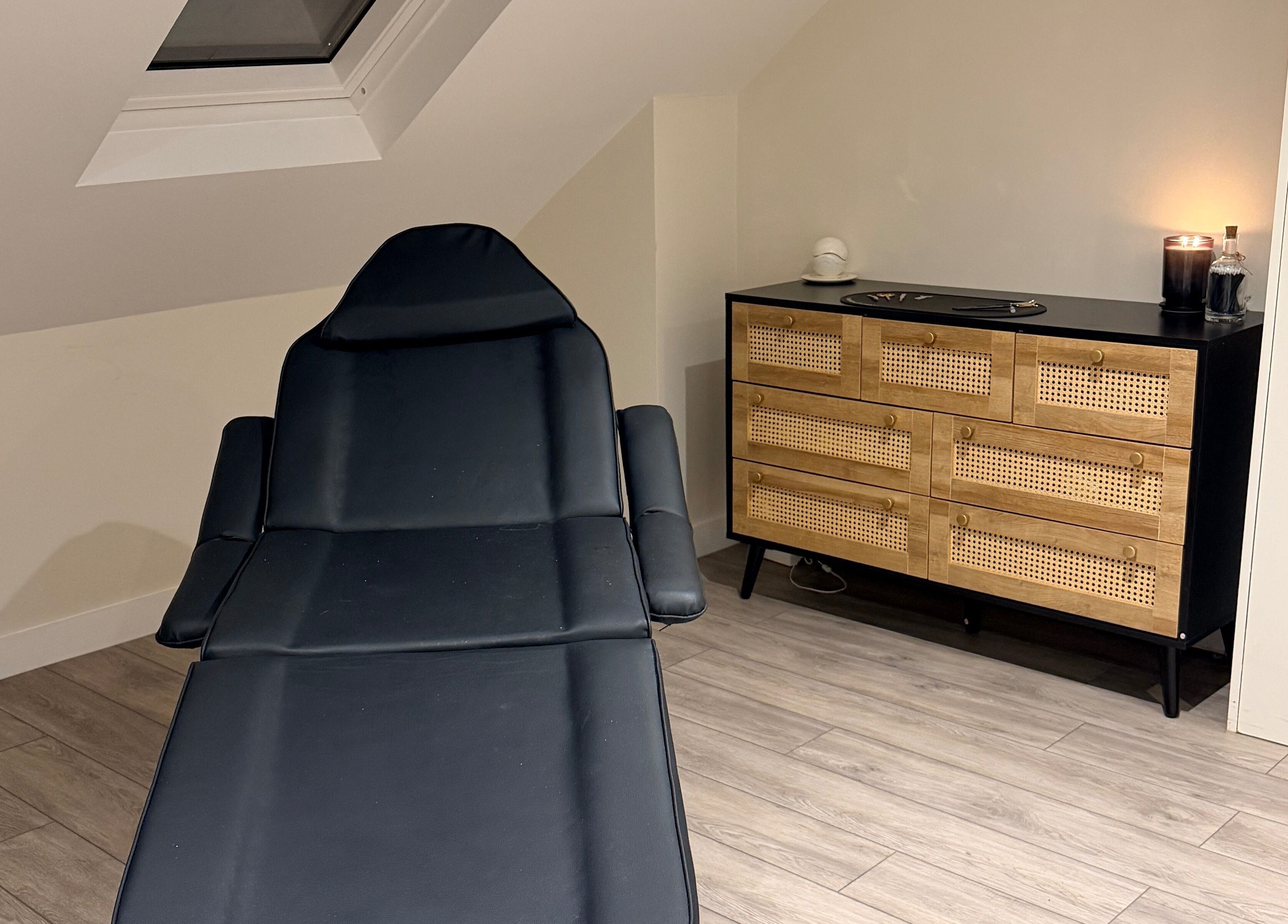 Sophisticated treatment room at Brows by GG, Bristol, England, GB with modern chair and wicker dresser.