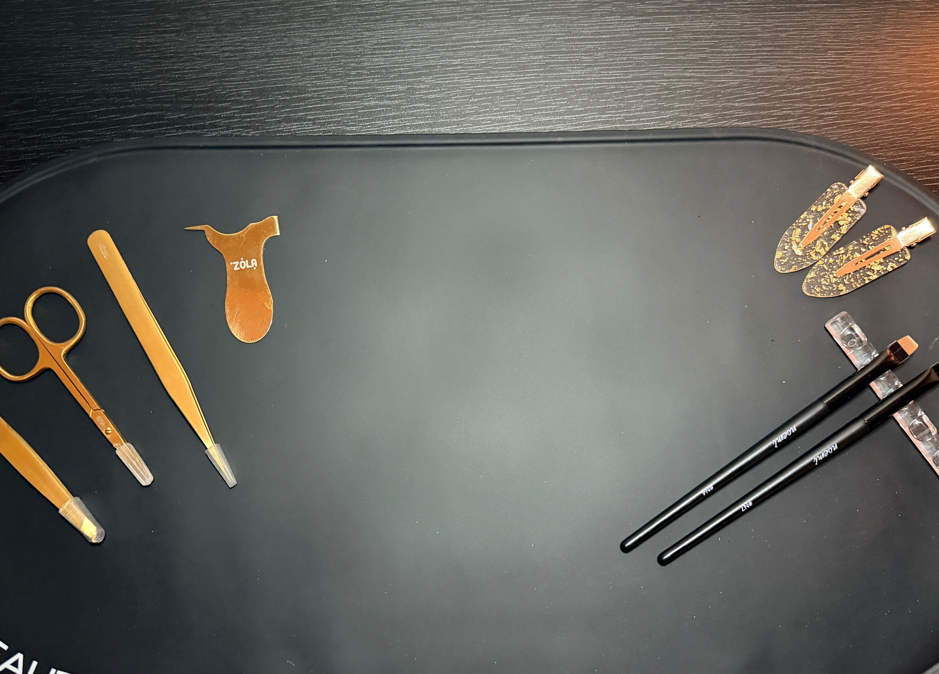 Elegant gold beauty tools at Brows by GG, Bristol, England, GB, showcasing premium eyebrow care equipment.