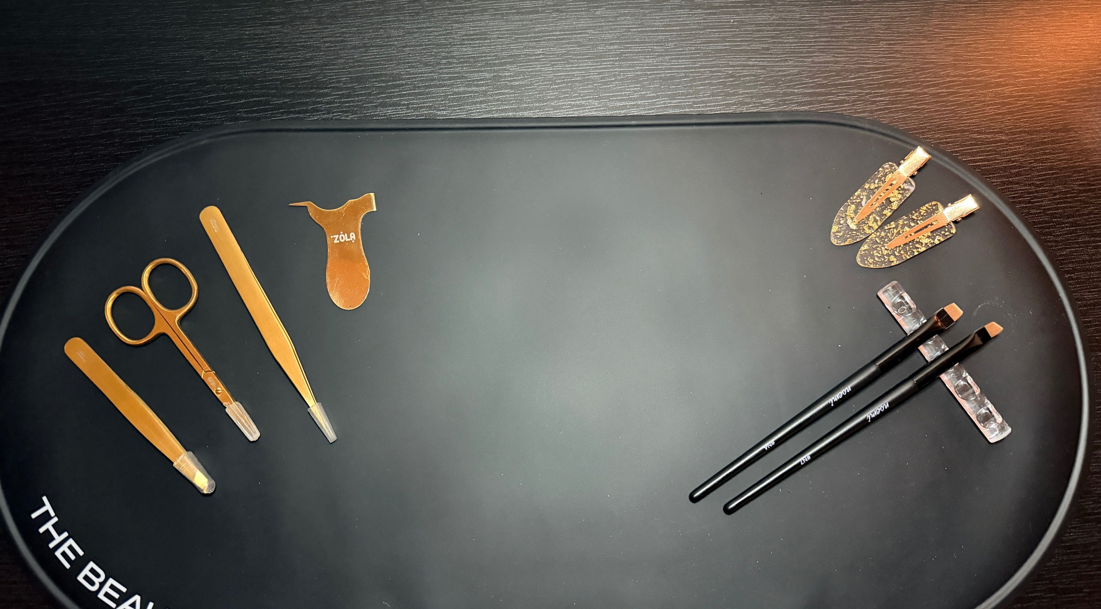 Elegant gold beauty tools at Brows by GG, Bristol, England, GB, showcasing premium eyebrow care equipment.