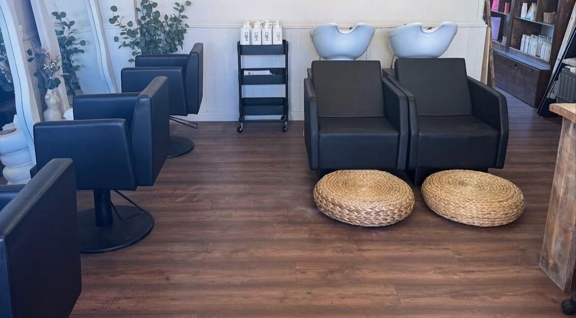 Defined Beauty salon interior in Plymouth, England, GB with chic seating and modern washing stations.