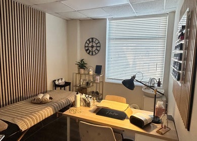 Relaxing treatment room at Glow up with Claire, Bingley, England, GB, featuring a comfortable therapy bed and soft lighting.