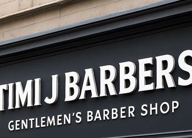 Signage of TIMIJBARBERS in Paisley, Scotland, GB, highlighting gentlemen's barber shop.
