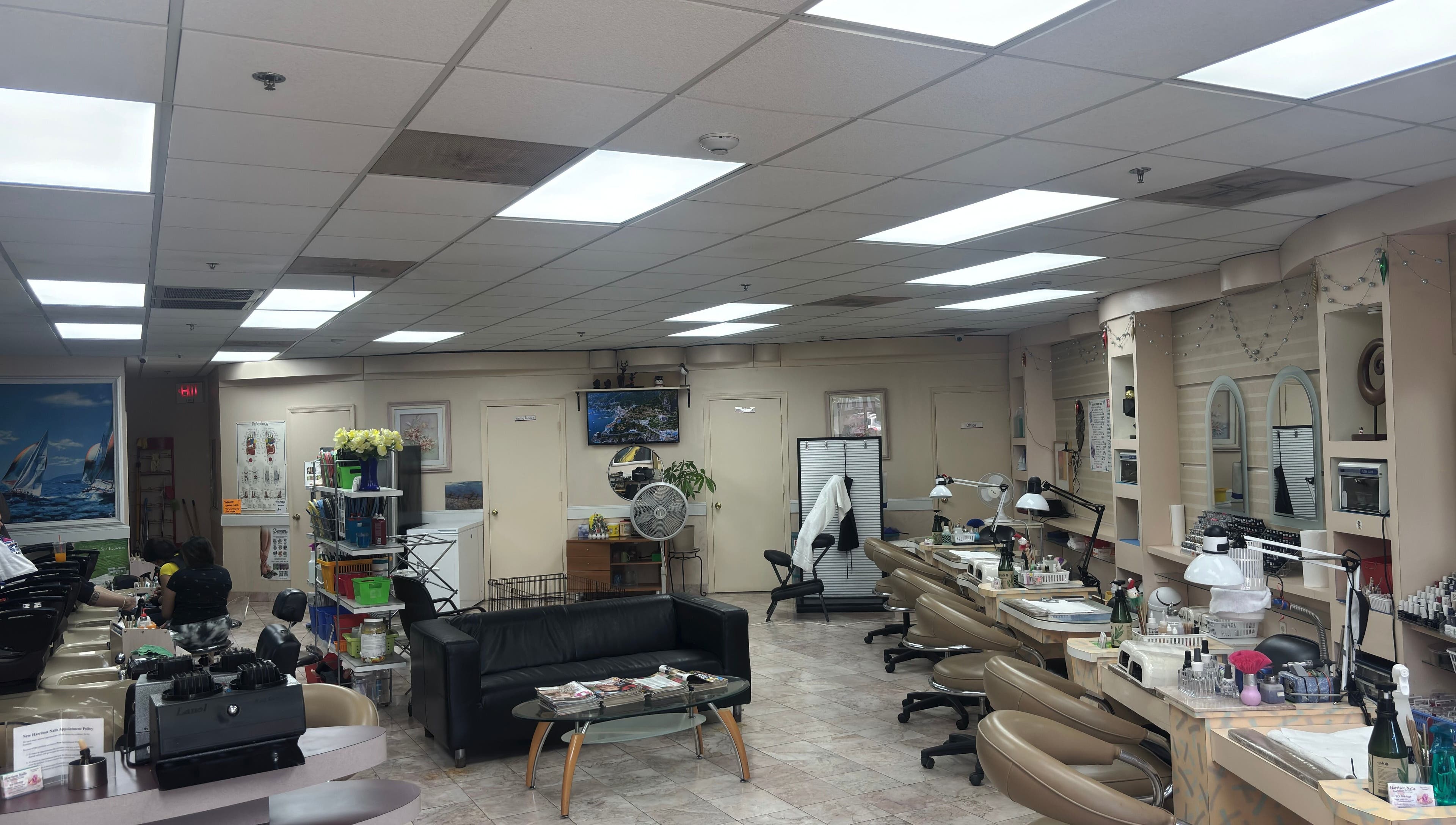 Bright, welcoming interior of Harrison Nails NJ in Harrison, New Jersey, with manicure stations and comfortable seating.