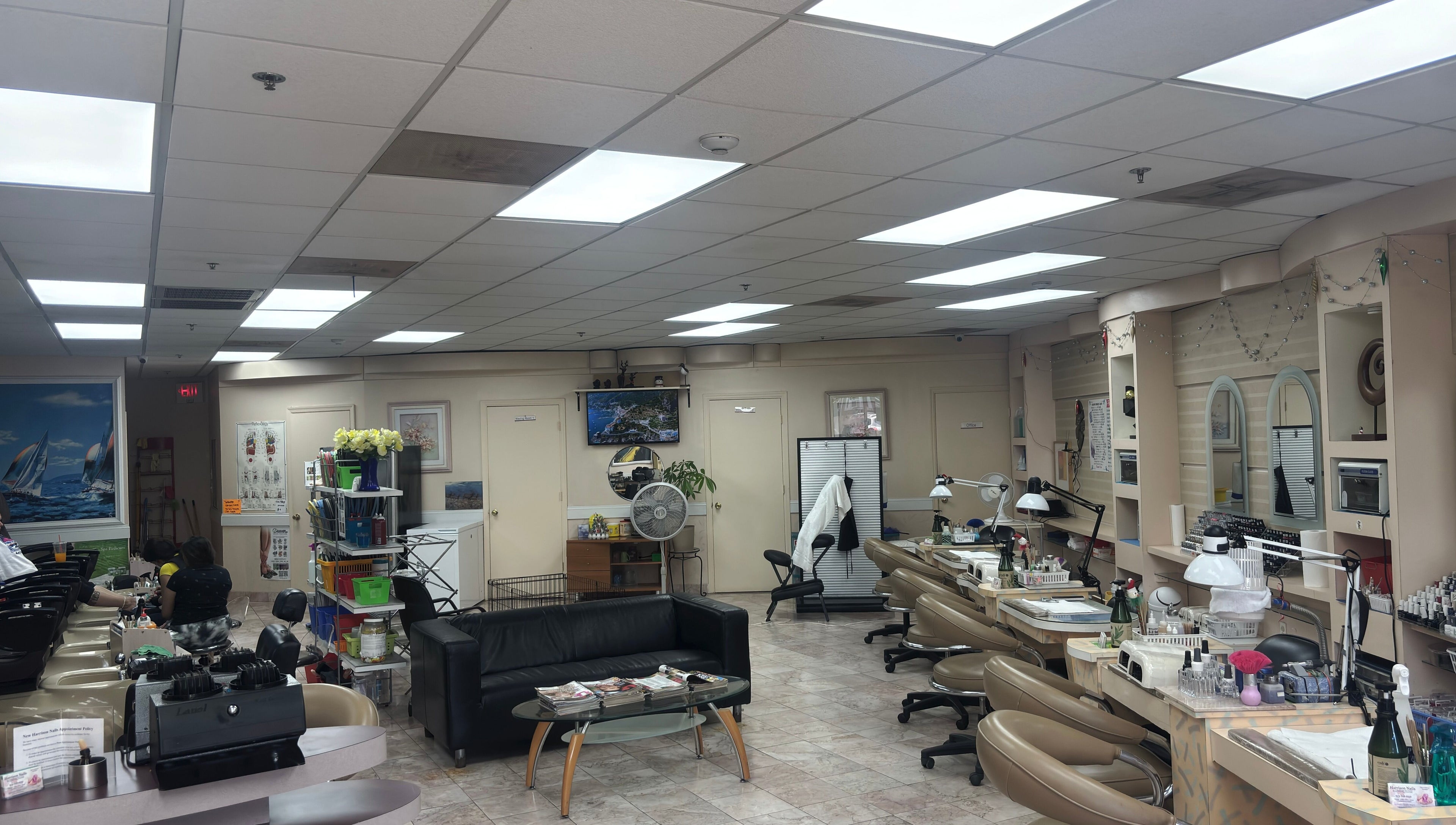 Bright, welcoming interior of Harrison Nails NJ in Harrison, New Jersey, with manicure stations and comfortable seating.