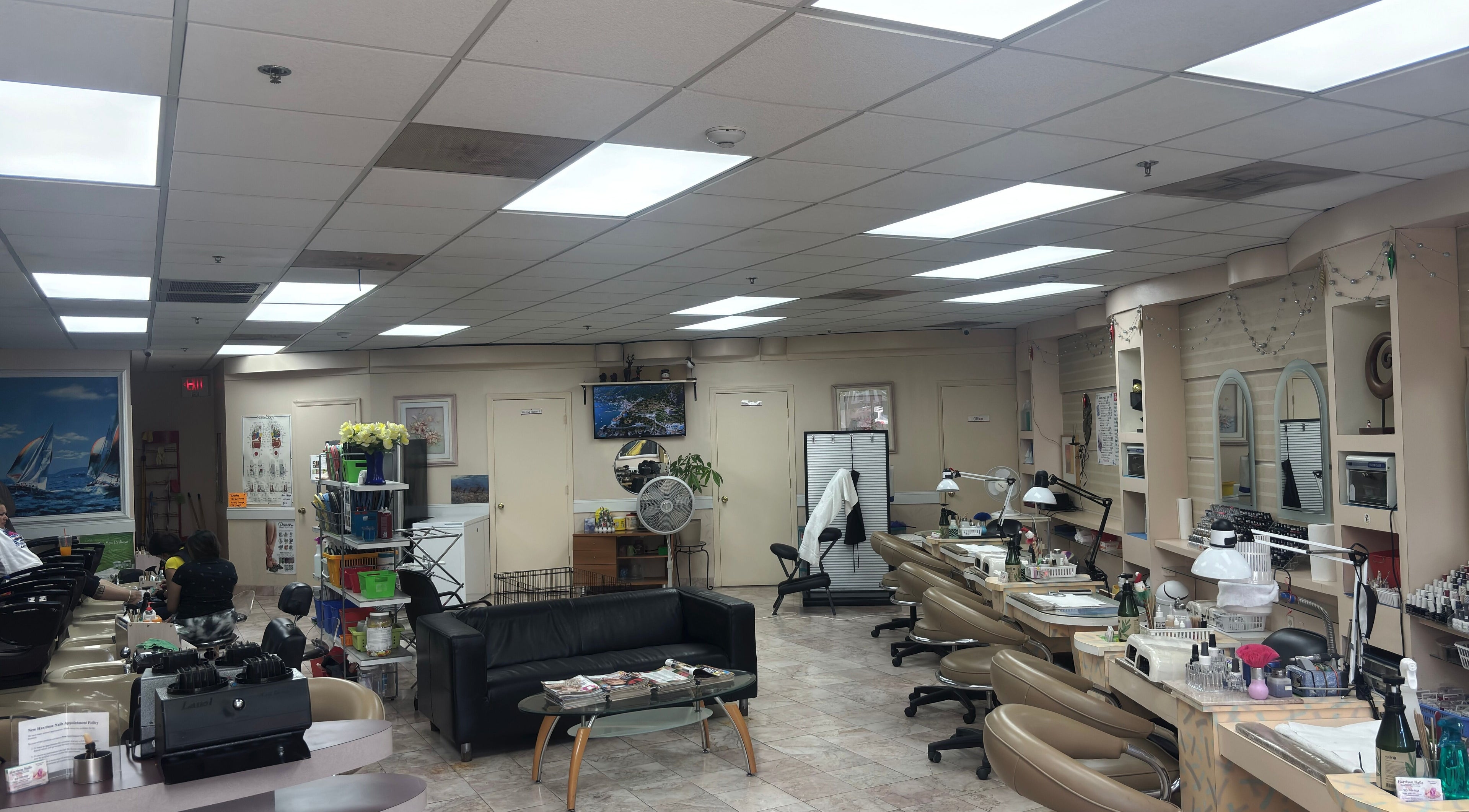 Bright, welcoming interior of Harrison Nails NJ in Harrison, New Jersey, with manicure stations and comfortable seating.