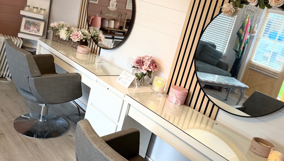 Elegant vanity area at Pretty Hair Cabin, Stockton-on-Tees, England, GB with plush chairs and floral decor.