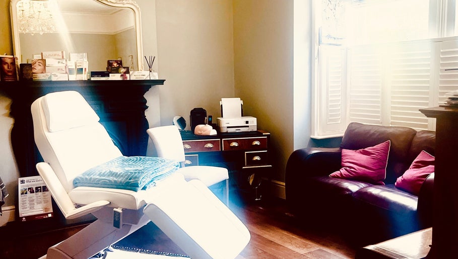 Elegant treatment room at LNLaesthetics in Addlestone, England, GB showcasing a cozy and inviting atmosphere.