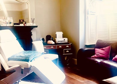 Elegant treatment room at LNLaesthetics in Addlestone, England, GB showcasing a cozy and inviting atmosphere.