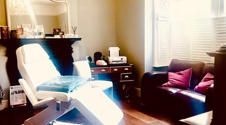 Elegant treatment room at LNLaesthetics in Addlestone, England, GB showcasing a cozy and inviting atmosphere.