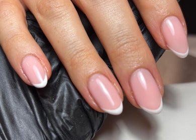 Stylish French manicure at Kayas Beauty Room, Stevenage, England, GB showcasing elegant pink and white nails.