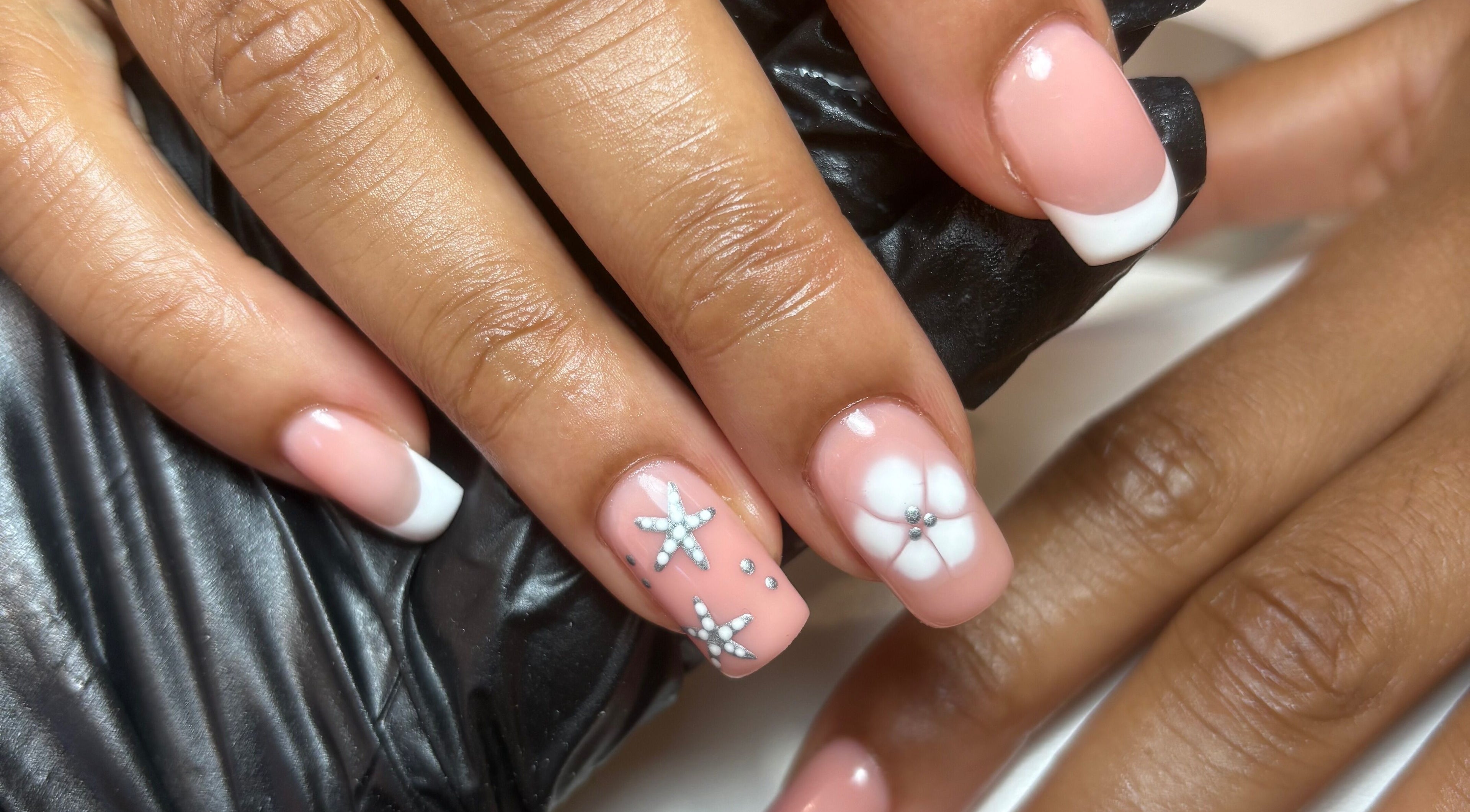 Elegant floral nail art at Kayas Beauty Room in Stevenage, England, GB showcases detailed white accents.