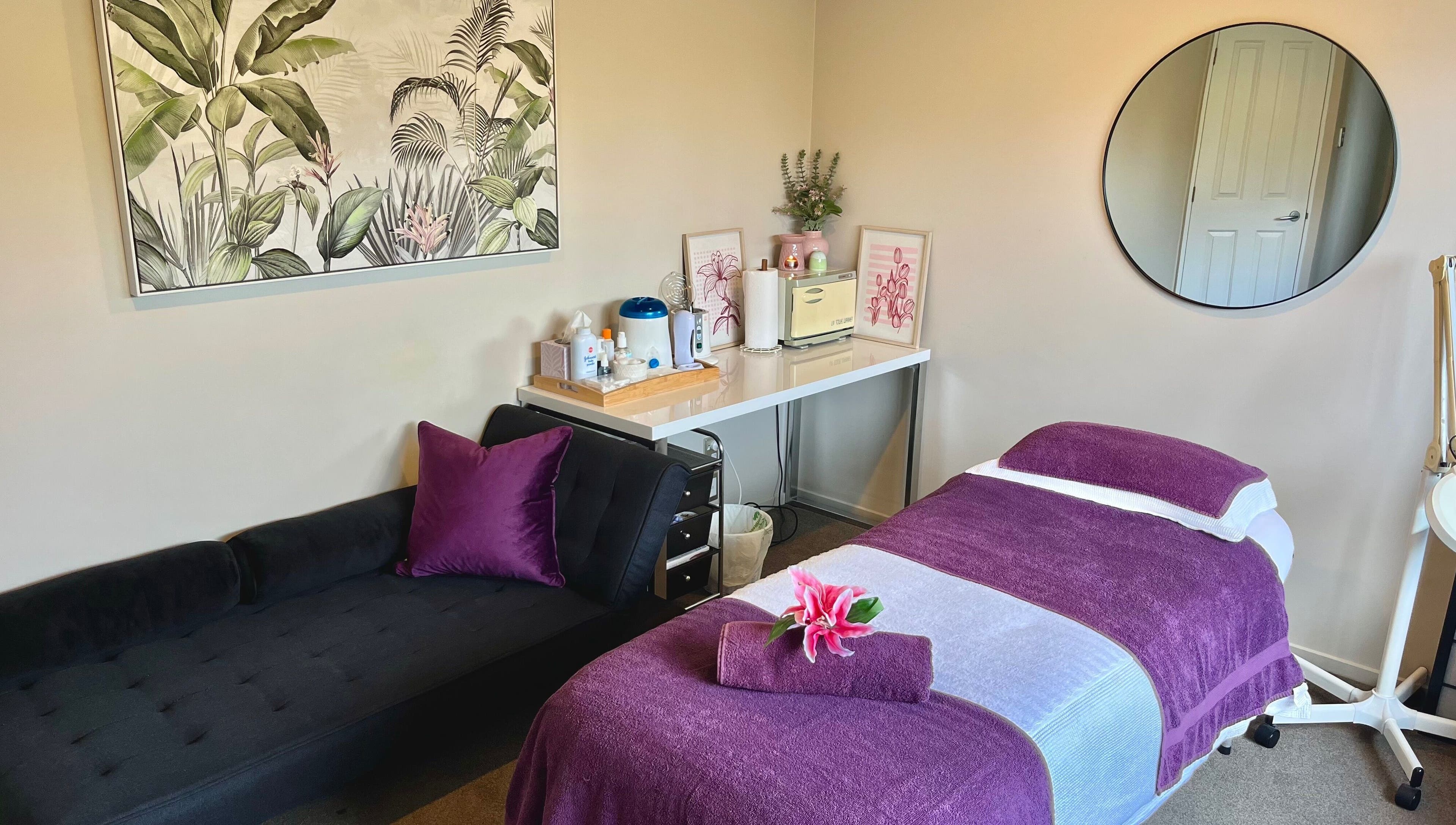 Relaxing massage room at Selene Beauty, Christchurch, Canterbury Region, NZ. Includes purple accents and nature art.