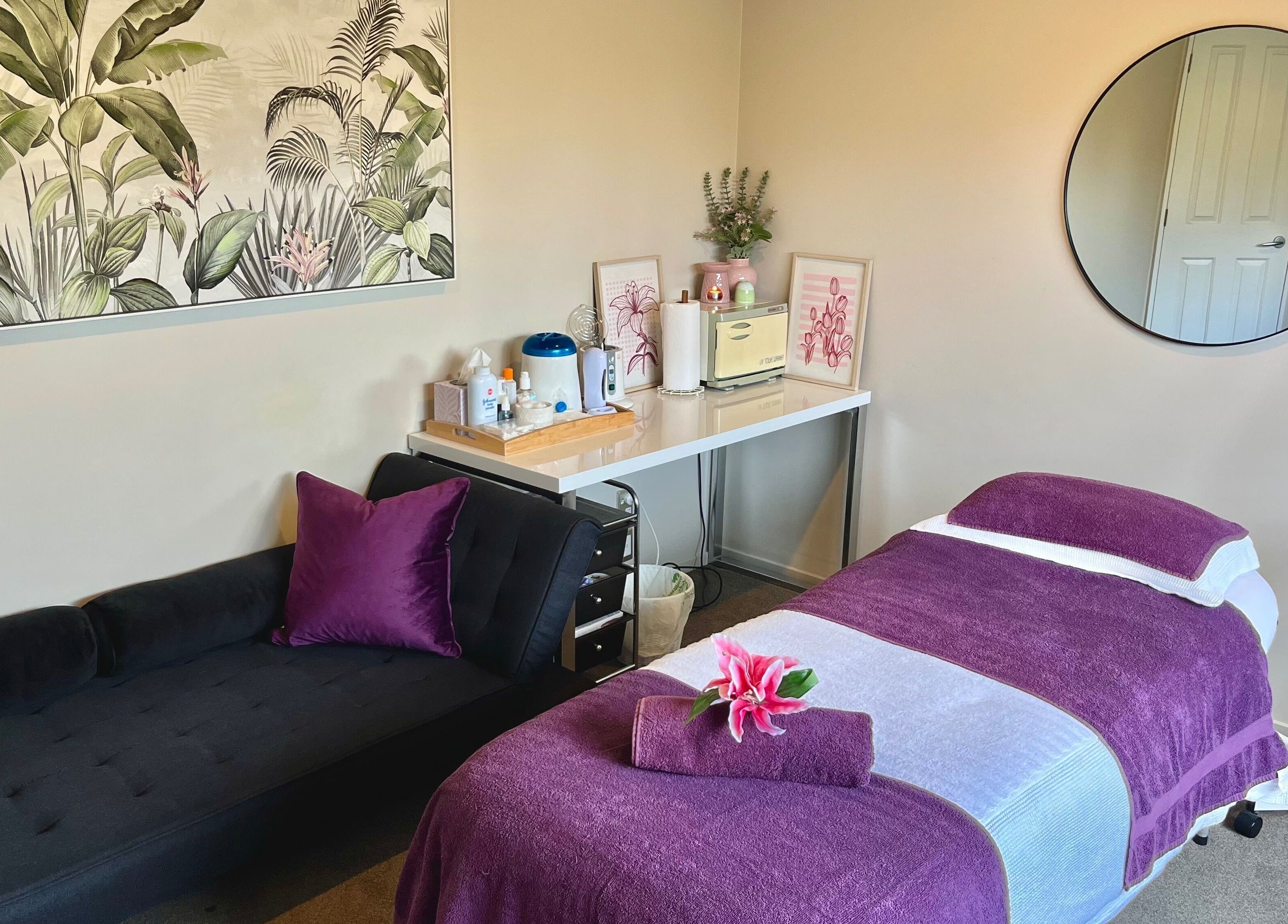 Relaxing massage room at Selene Beauty, Christchurch, Canterbury Region, NZ. Includes purple accents and nature art.