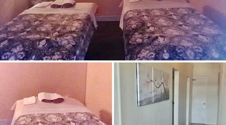 Relaxing massage room at Foot Massage in Austin, Texas, US with two cozy beds and calming decor.