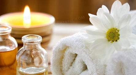 Relaxing Foot Massage setting in Austin, Texas, US featuring candle, oils, and flower.