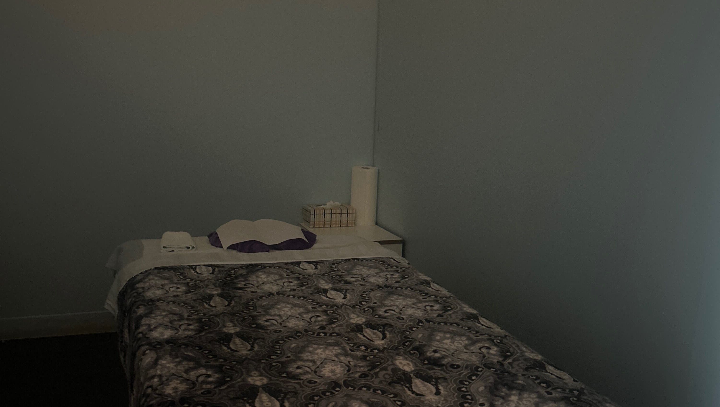 Cozy massage room at Asain Foot Massage in Austin, Texas, US, featuring a comfortable bed and soft lighting.