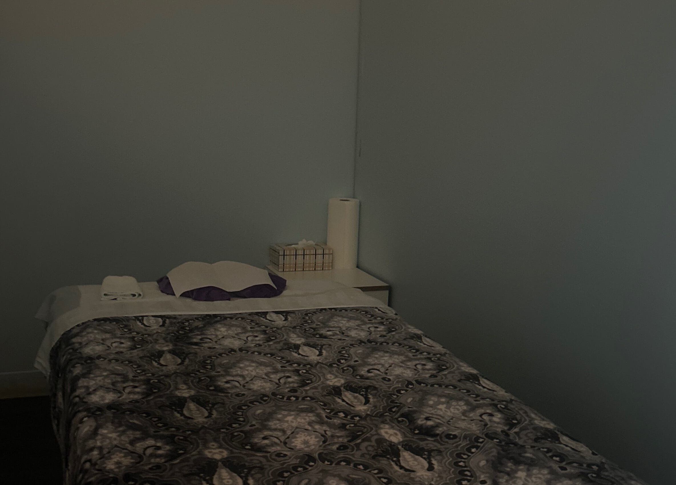 Cozy massage room at Asain Foot Massage in Austin, Texas, US, featuring a comfortable bed and soft lighting.