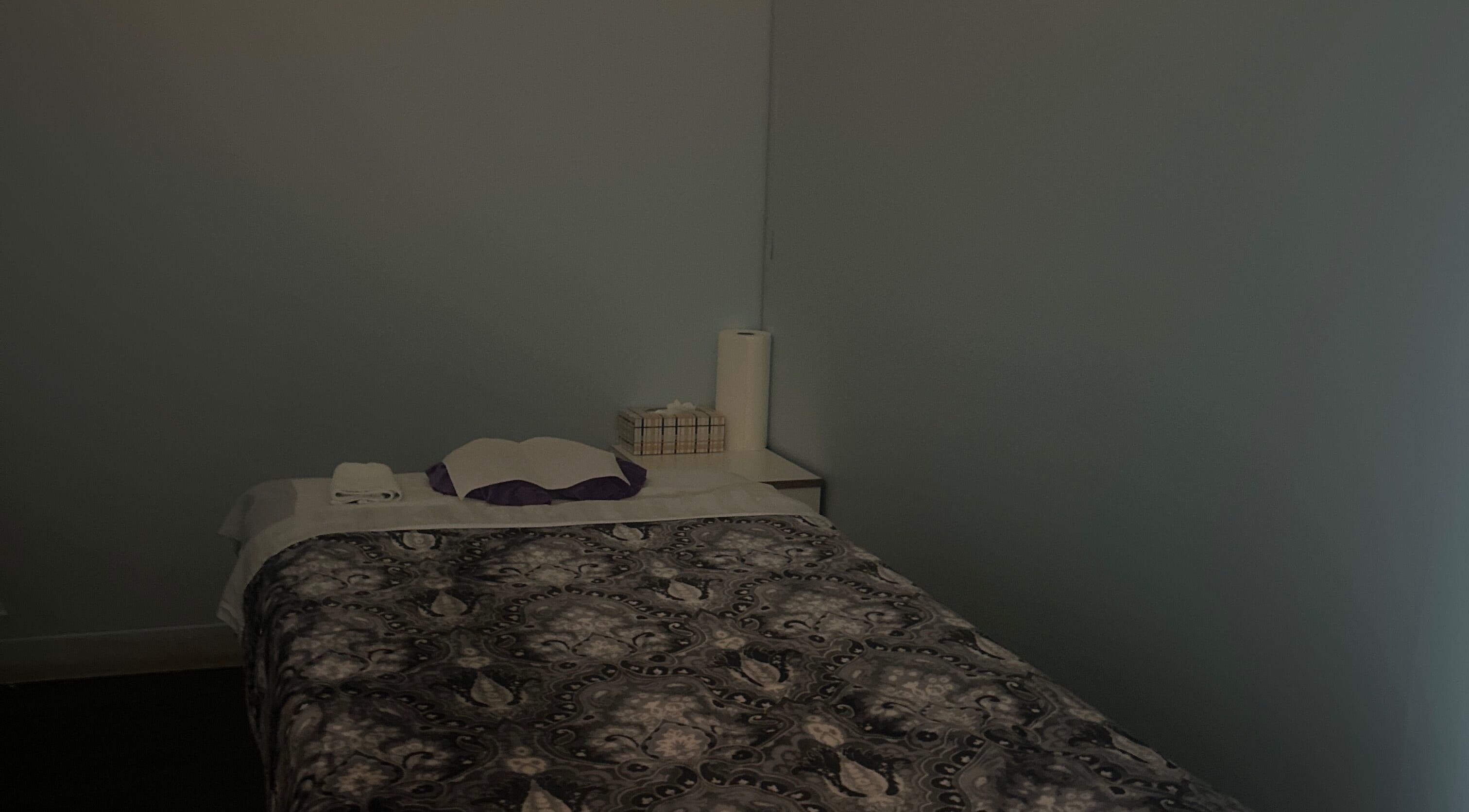 Cozy massage room at Asain Foot Massage in Austin, Texas, US, featuring a comfortable bed and soft lighting.