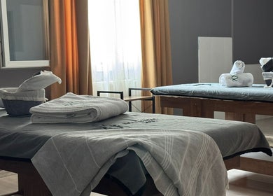 Relaxing treatment room at Novva Spa & Beauty Center, İstanbul, İstanbul, TR, featuring massage tables and soft towels.
