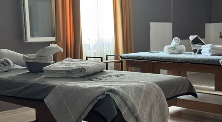 Relaxing treatment room at Novva Spa & Beauty Center, İstanbul, İstanbul, TR, featuring massage tables and soft towels.