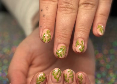 Green leaf nail art at SCULPTED BY LIZA in Bowling Green, Ohio, US, showcasing intricate design work.